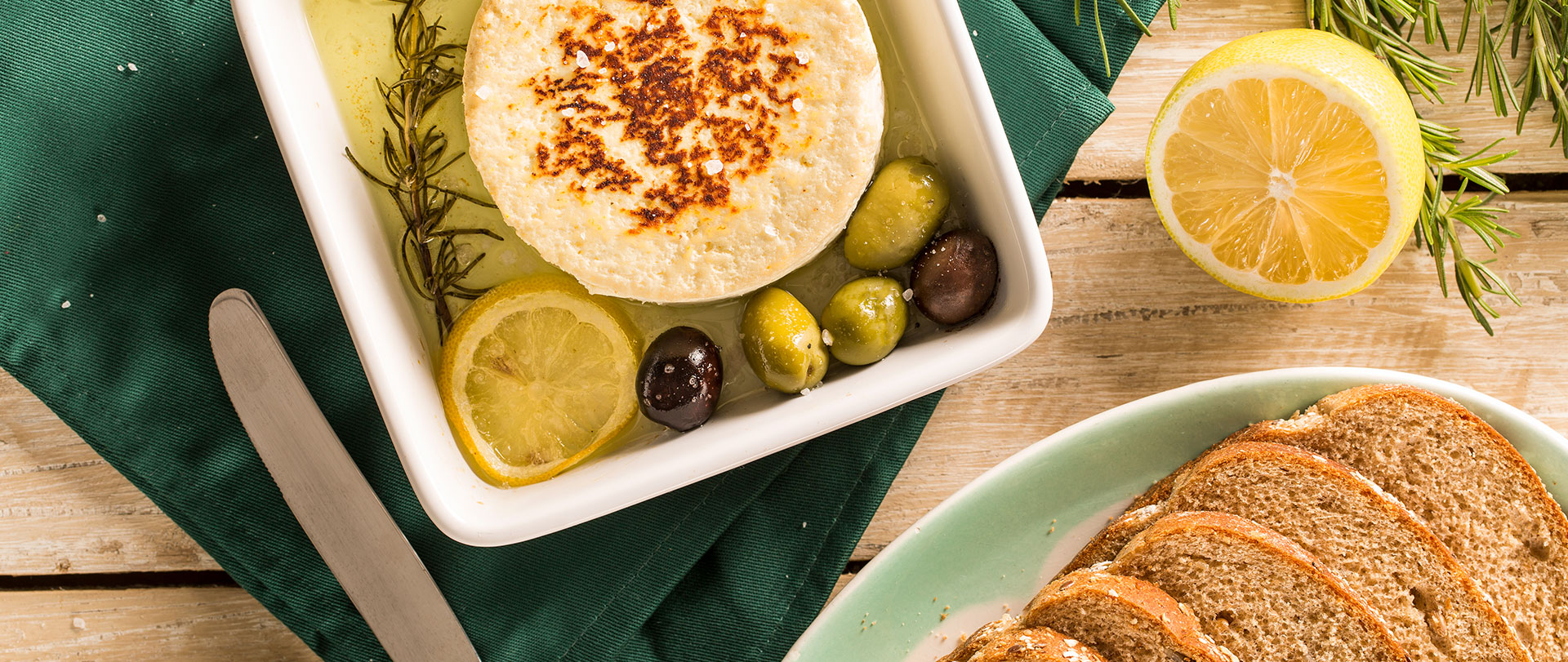 Queijo com azeite, azeitonas e limão, servido com pão integral